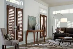 A living room with wooden shutters and a table
