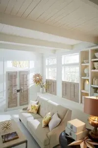 A living room with white walls and beige furniture.