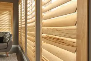 A wooden window with blinds closed on the outside.